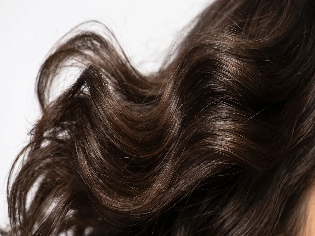 Glossy, bouncy blowout hair texture showcasing smooth cuticle alignment