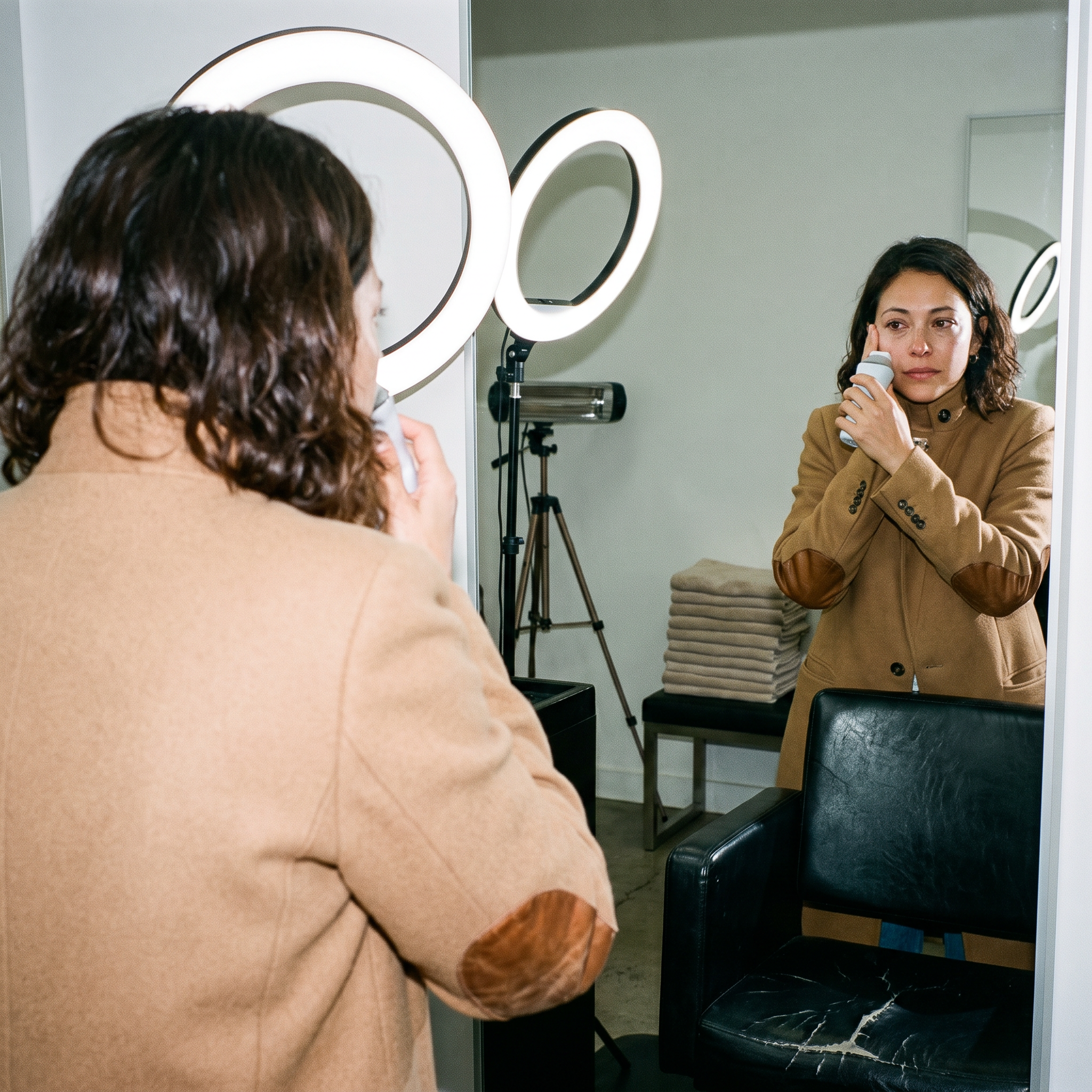 Avery demonstrating facial lymphatic drainage with a chilled stainless steel massage roller along the jawline