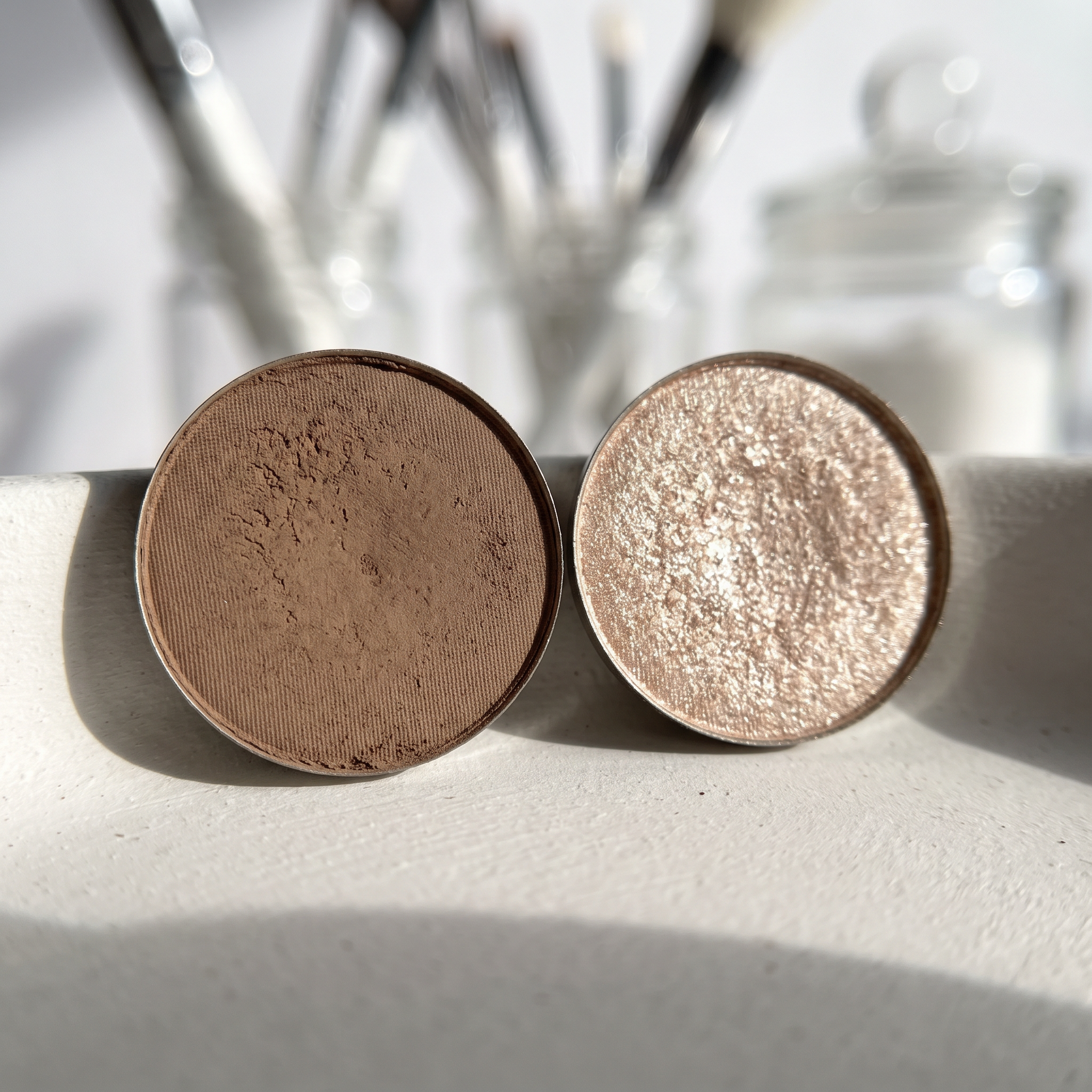 Macro comparison of a velvety matte brown pan and a fine-shimmer champagne pan side by side