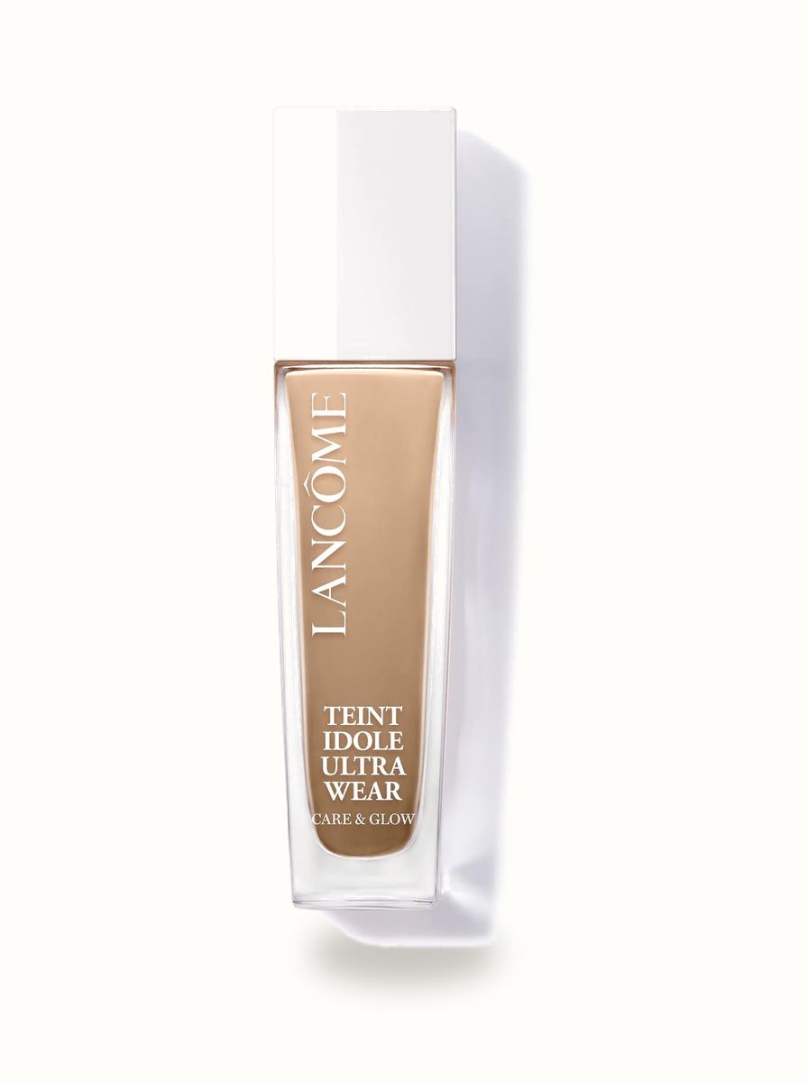 Lancôme Teint Idole Ultra Wear Care and Glow Foundation bottle with gold crest on warm porcelain background