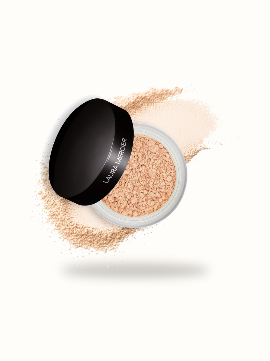 Laura Mercier Translucent Loose Setting Powder open jar with micro-milled powder burst on warm porcelain background