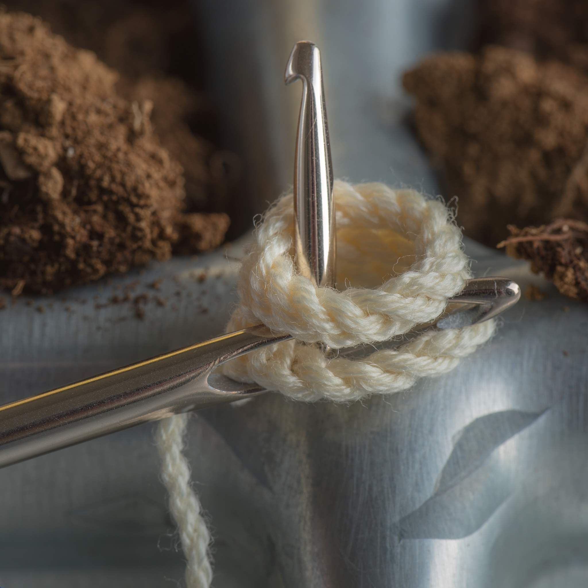 Hook holding two loops for crochet decreasing stitches before the final pull-through